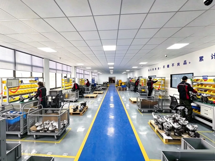 Turbocharger assembly line at partner plant — operators at ESD-safe workstations